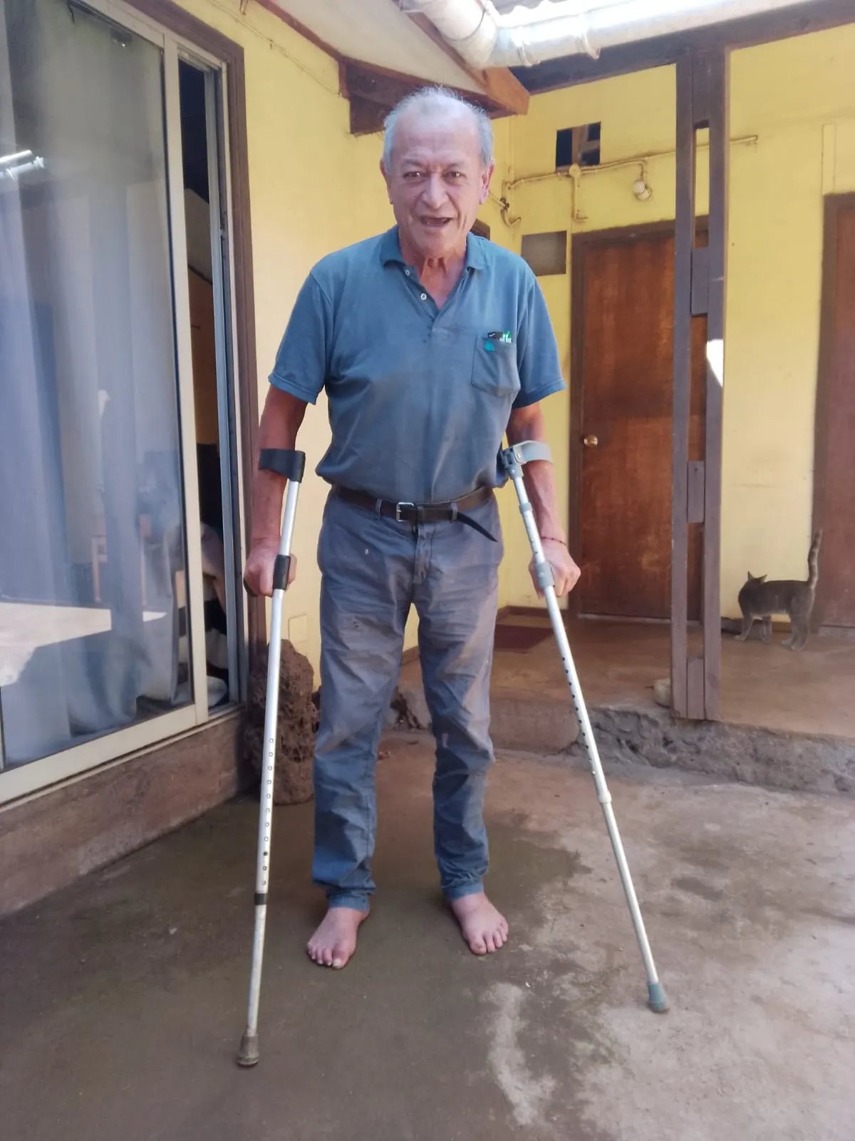 Disabled Rapa Nui man using old crutches at home on Easter Island